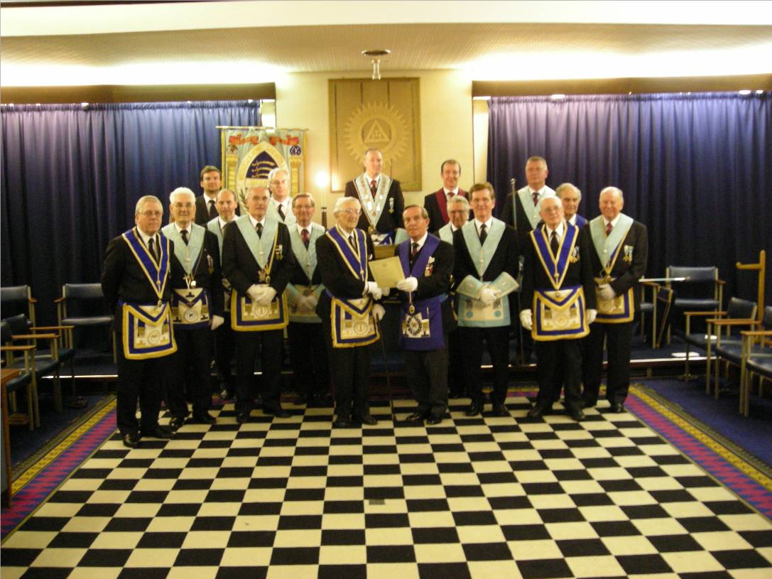 W.Bro. Peter being presented with his 100th Birthday certificate by W.Bro. Mike Goody with the members of the Middlesex Home Service Lodge